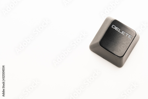 black keyboard button with a white inscription Delete in the corner on a white background photo