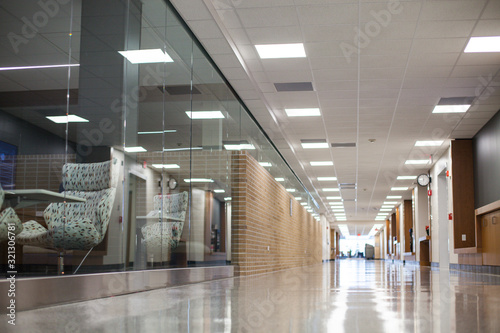 Hall in empty college building. Cafe behind glass wall