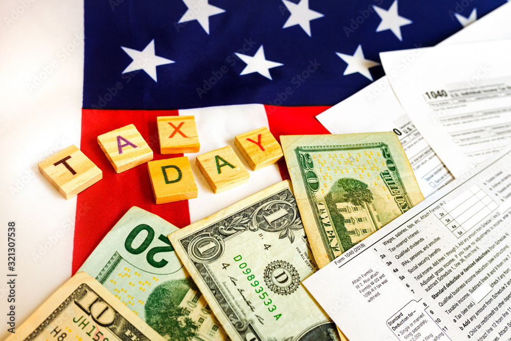 Composition on the day of tax payment in April with banknotes and tax form. Composition on the day of tax payment in April with banknotes and tax form.