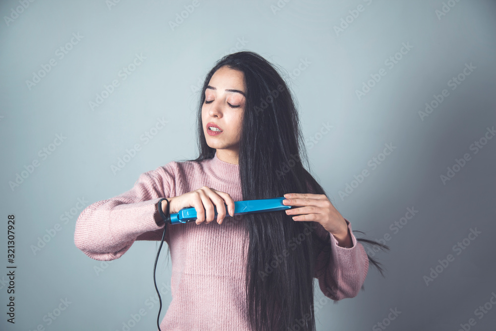 woman hand hair ironing woman hand hair ironing