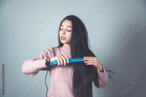 woman hand hair ironing
