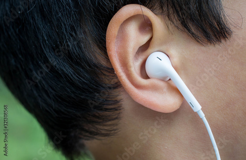 White earbuds in boys ears