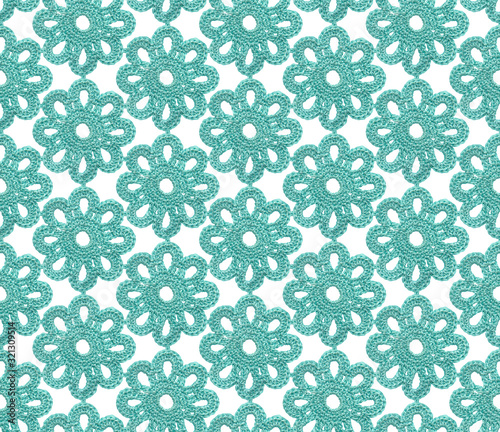 Crochet irish lace seamless pattern. The canvas is knitted with blue yarn.