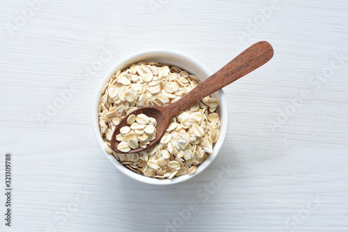 Natural oatmeal on light wooden background