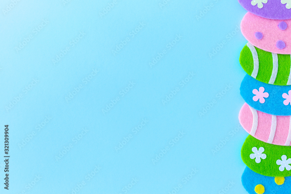 Cute blue Easter holiday photo background with colorful handmade eggs.