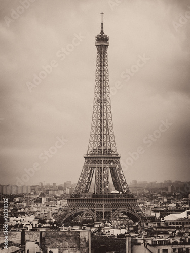 Fototapeta Naklejka Na Ścianę i Meble -  Eiffel tower and rooftops, Paris, France, vintage old photo effect, grainy sepia image