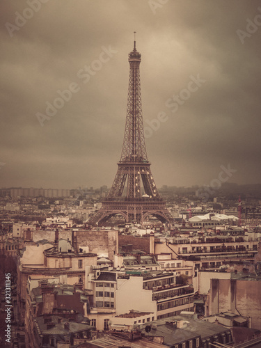 Eiffel tower and rooftops, Paris, France, vintage old color photo effect, view from Arc de Triomphe.