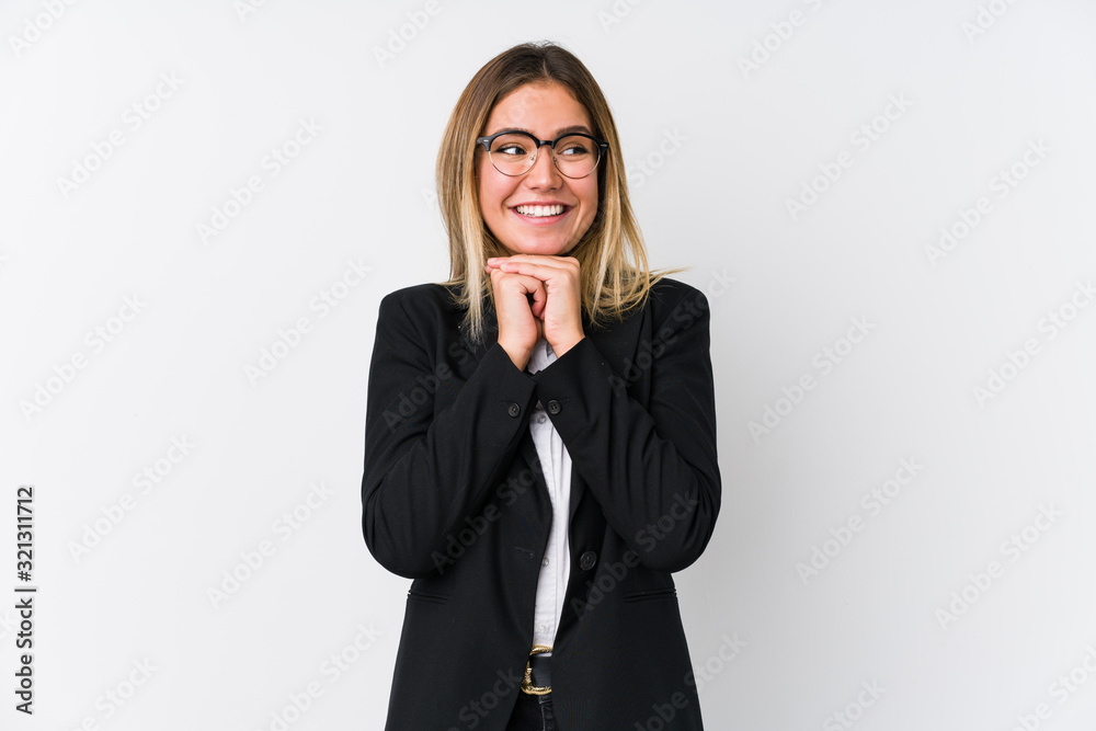 Young business caucasian woman keeps hands under chin, is looking happily aside. Young business caucasian woman keeps hands under chin, is looking happily aside.