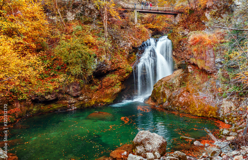 Wonderful Autumn landscape with Beautiful little waterfall in forest. Waterfall at Soteska vintgar, Slovenia. The Vintgar Gorge in Julian Alps, Slovenia. or Bled Gorge. Amazing nature Scenery