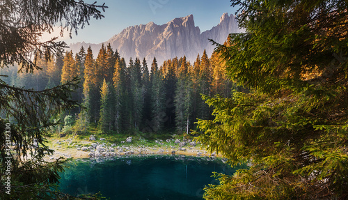 Incredible nature landscape.Sunny autumn day in Dolomites Alps. Lake Carezza with Mount Latemar, Bolzano province, South tyrol, Italy. popular travel locations. Picture of wild area © jenyateua