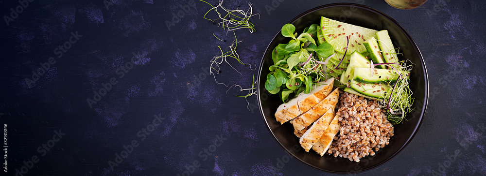 Lunch salad. Buddha bowl with buckwheat porridge, grilled chicken fillet, corn salad, microgreens and daikon. Healthy food. Top view, banner Lunch salad. Buddha bowl with buckwheat porridge, grilled chicken fillet, corn salad, microgreens and daikon. Healthy food. Top view, banner