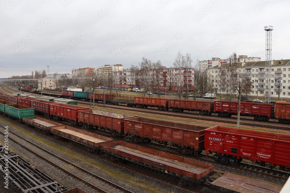 Red freight cars on railroad tracks against the background of houses. Red freight cars on railroad tracks against the background of houses.