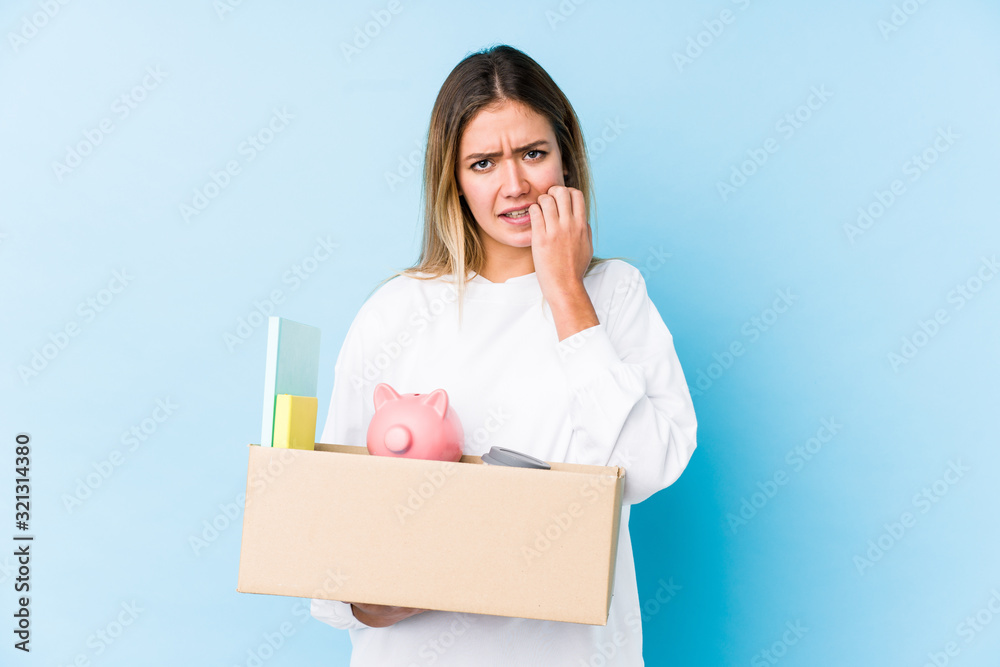 Young caucasian woman moving home isolated biting fingernails, nervous and very anxious. Young caucasian woman moving home isolated biting fingernails, nervous and very anxious.