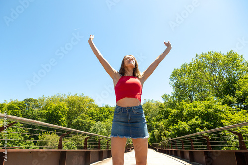 Happy young beautiful woman feeling free in nature