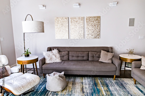 Mid century modern contemporary style living room den in a spacious open home with a vaulted ceiling and a pine wood ceiling and neutral gray couch and furniture photo