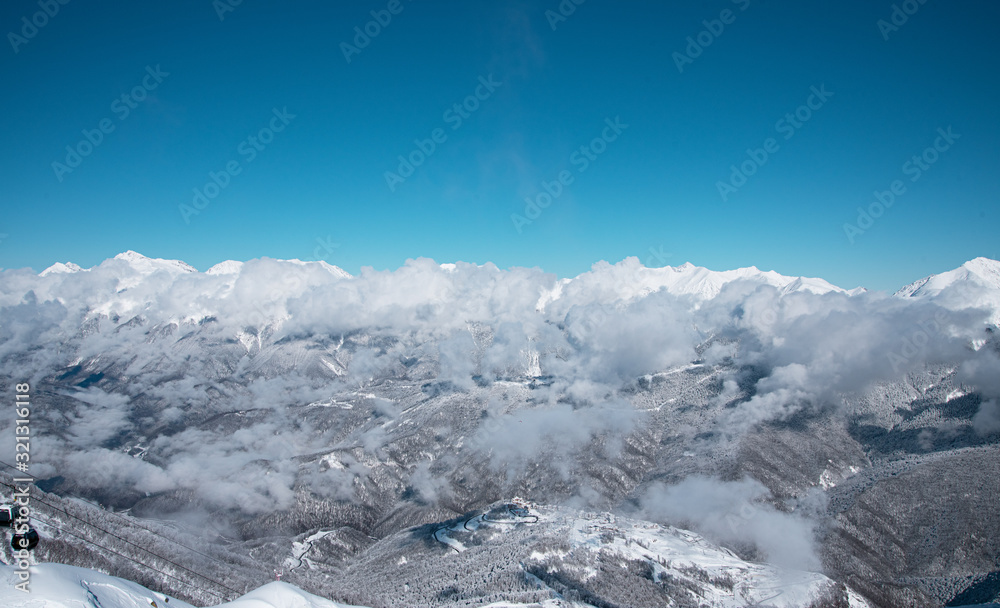 mountain ski resort Rosa Khutor in Sochi.  Winter sunny day with cloudy .