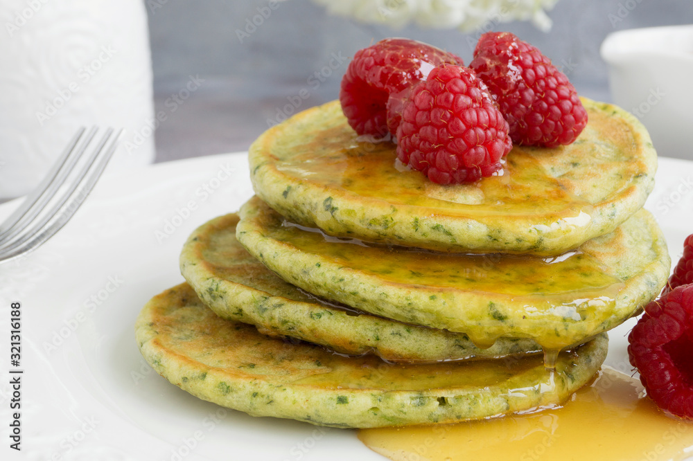 vegetarian spinach pancakes with raspberries and honey. vegetarian spinach pancakes with raspberries and honey.