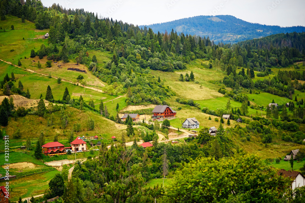 Amaizing view of houses in Carpathian mountains in west part of Ukraine. Famous ukrainian mountains Carpathians. Scenic landscape. Popular tourist destination for summer and winter holidays