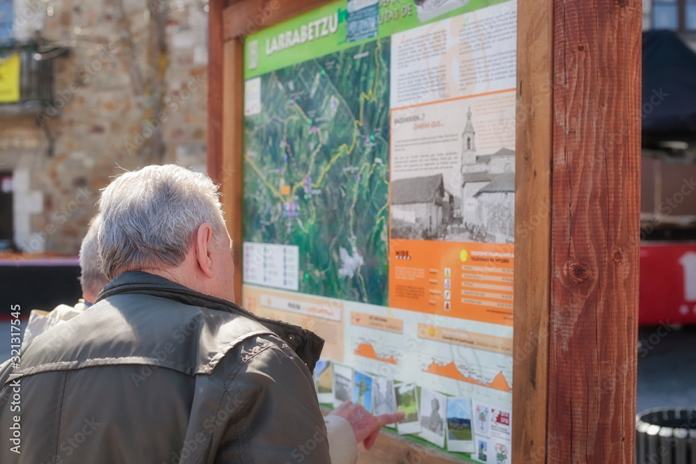 Mar. 19, 2017; Larrabetzu, Bizkaia (Basque Country). Two gentlemen in the informative panel on nature routes in the municipality of Larrabetzu.