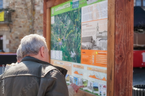 Mar. 19, 2017; Larrabetzu, Bizkaia (Basque Country). Two gentlemen in the informative panel on nature routes in the municipality of Larrabetzu. photo