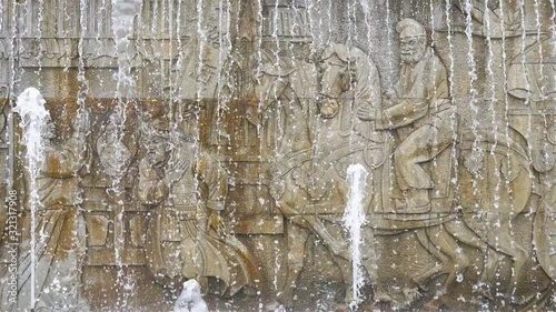 Beautiful stone rock mural of ancient people in traditional dress and water flow in Dayan Pagoda, Xian China