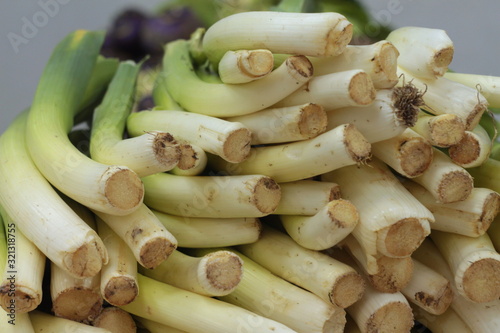 A large pile of stalks of green celery lies on a counter in a store.