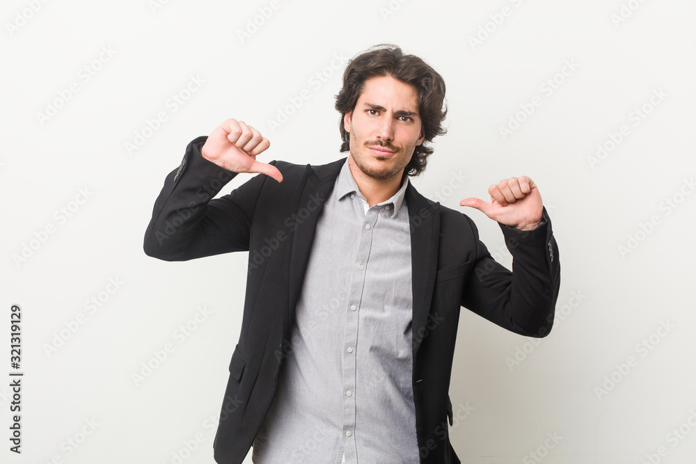 Young business man against a white background feels proud and self confident, example to follow. Young business man against a white background feels proud and self confident, example to follow.