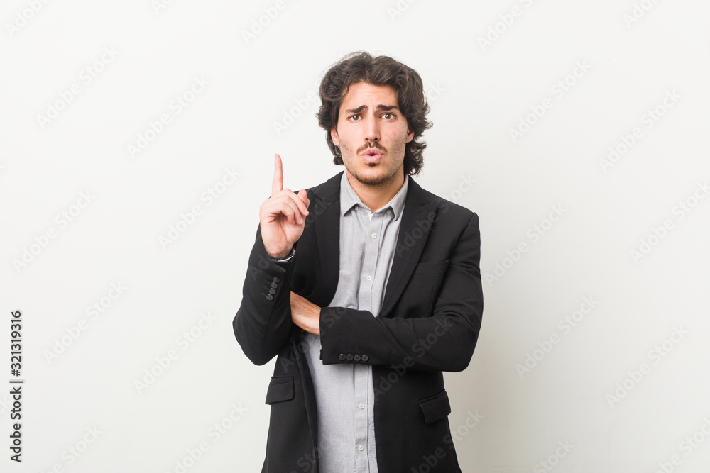 Young business man against a white background having some great idea, concept of creativity. Young business man against a white background having some great idea, concept of creativity.