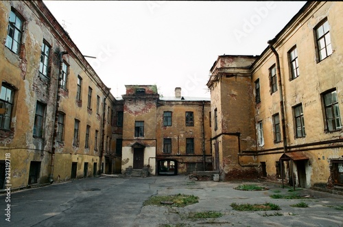 Sullen desolate yard with abandoned old red brick buildings in St.Petersburg, Russia