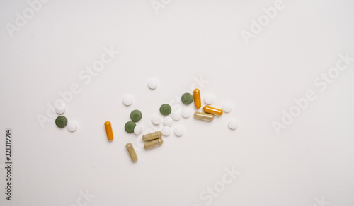 Medical pills and capsules isolated on white background. Top view. Copy space.