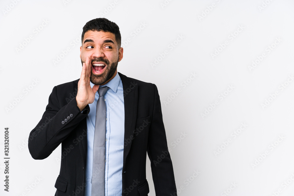Young latin business woman against a white background isolated is saying a secret hot braking news and looking aside Young latin business woman against a white background isolated is saying a secret hot braking news and looking aside