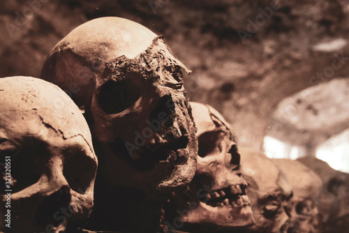 Photography Skulls. Group of mummified skulls inside an ancient crypt