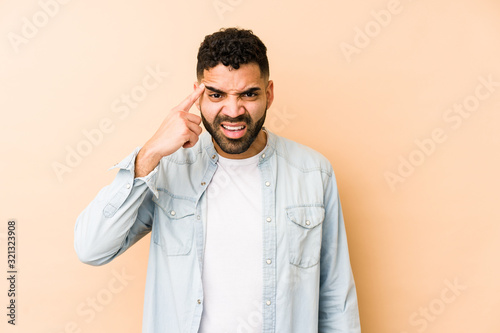 Young mixed race arabic man isolated showing a disappointment gesture with forefinger.