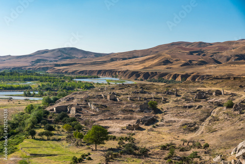 View of the landscape with an archeological site by the rock town of Uplistsikhe, Georgia on a beautiful sunny summer day