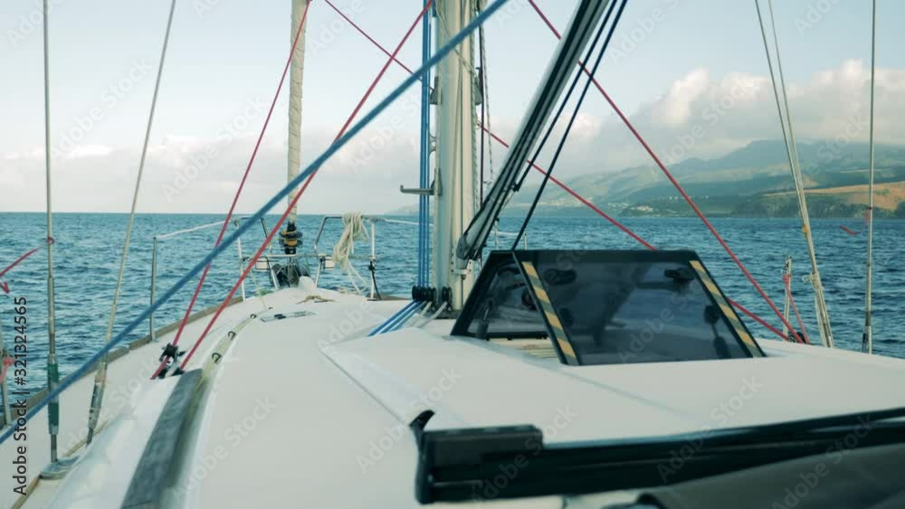 Front side of a yacht moving towards the coastline Front side of a yacht moving towards the coastline