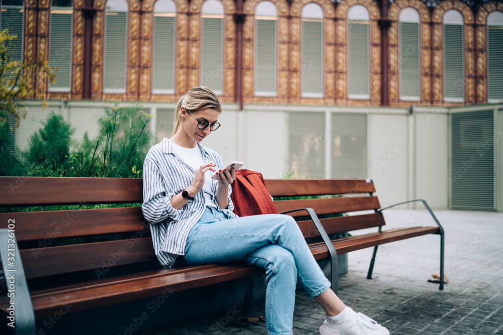 Attractive woman using smartphone on street bench Attractive woman using smartphone on street bench