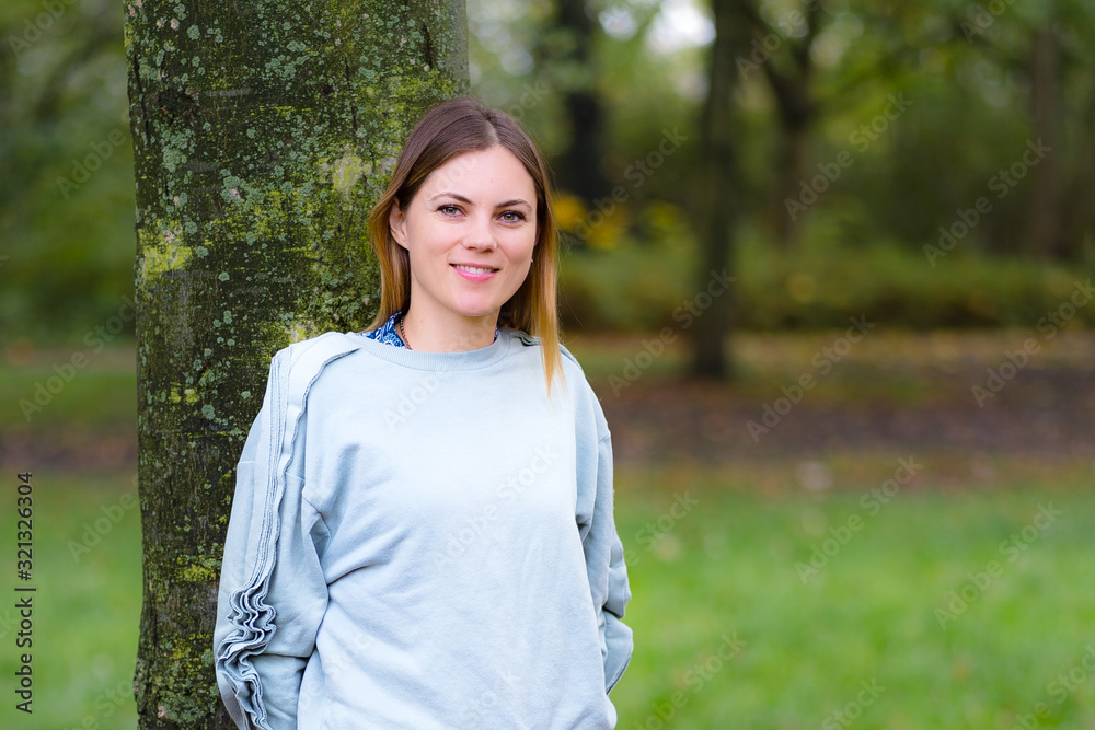 Happy Girl In Autumn Park, blurry background with copy space Happy Girl In Autumn Park, blurry background with copy space