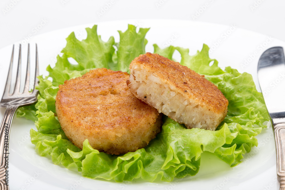 Cooked vegetarian cutlets on lettuce leaves. Fried breaded cutlet isolated on white background. freshly grilled burger vegetarian cutlets. Tasty crispy fried fresh cutlets. Juicy delicious cutlets