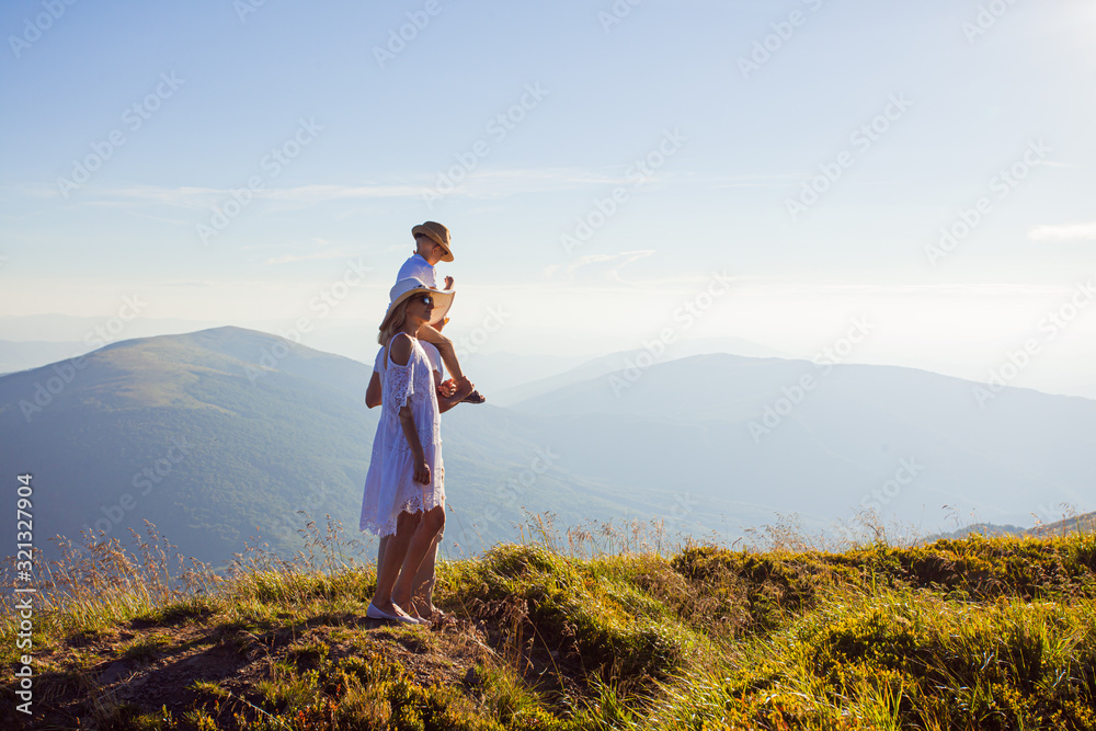 The family admires the mountain landscape at the morning