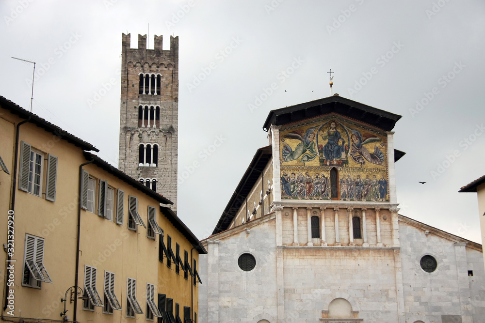 Toskana church old town in Italy. Facade wall of yellow orande house in tuscany. Romantic scenery inLucca.