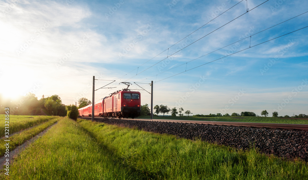 Red train traveling in a summer landscape. Train in nature Red train traveling in a summer landscape. Train in nature