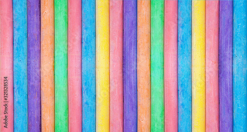 Pattern backdrop from row of Multicolored Chalks Crayons on Blue Blackboard Background. Arts creativity drawing education concept. Creative long banner poster with copy space