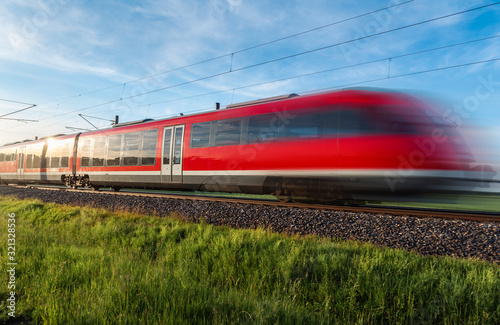 High-speed german train traveling through nature. Summer travel
