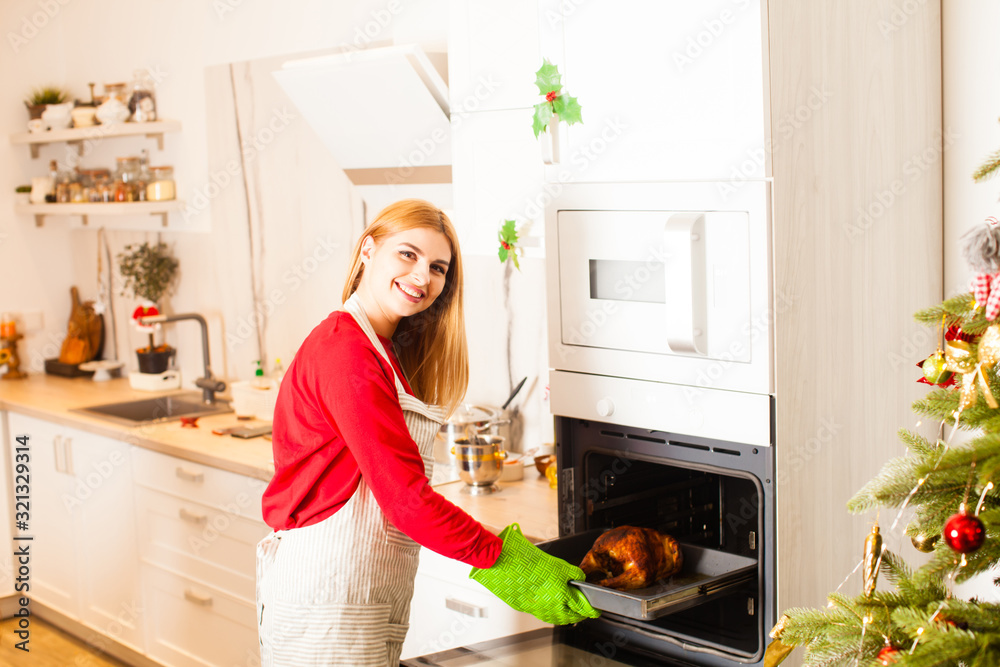 Young housewife cooking for her family at Christmas Young housewife cooking for her family at Christmas