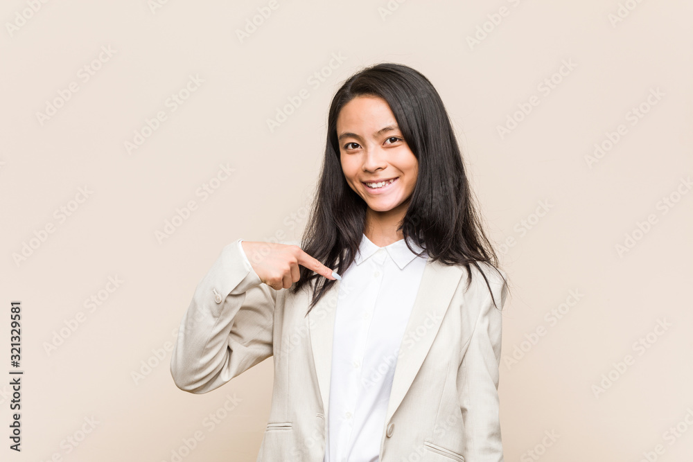 Young business chinese woman person pointing by hand to a shirt copy space, proud and confident Young business chinese woman person pointing by hand to a shirt copy space, proud and confident