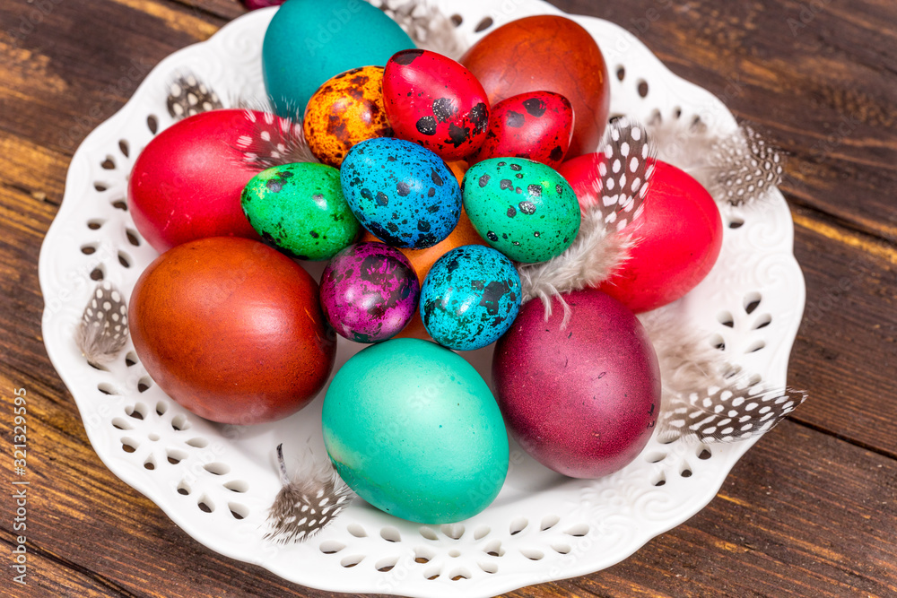 Fototapeta premium Happy Easter. Painted eggs of different colors on a wooden table