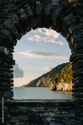 Liguria's Coastline view through a stone wall, Portovenere, Italy