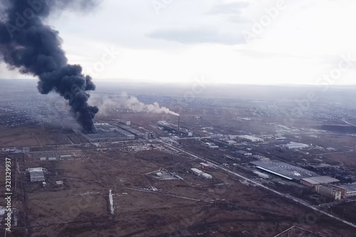 major fire at the factory. dark puffs of smoke from buildings.