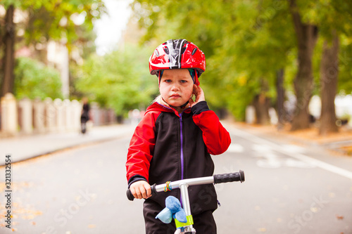 Girl in safety helmet riding a balance bike