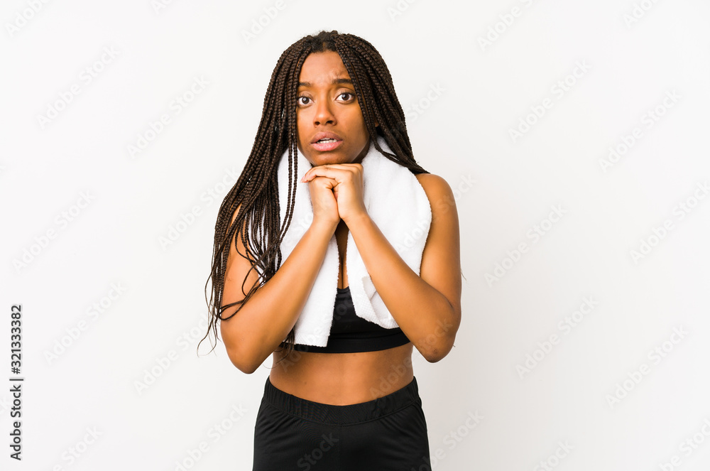 Young african american sport woman isolated praying for luck, amazed and opening mouth looking to front. Young african american sport woman isolated praying for luck, amazed and opening mouth looking to front.